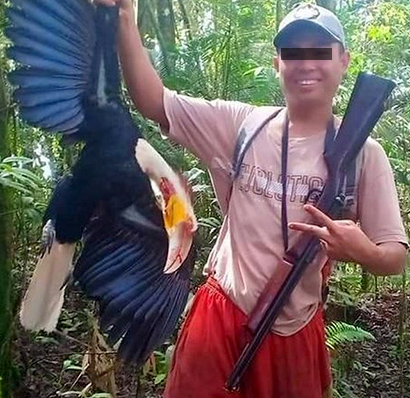 Photograph of a Man Who Shot Dead a Hornbill Went Viral on the Social Media (June 19, 2019).